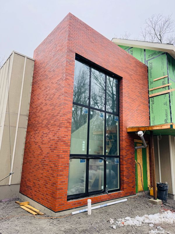 A brick building with a lot of windows is being built.
