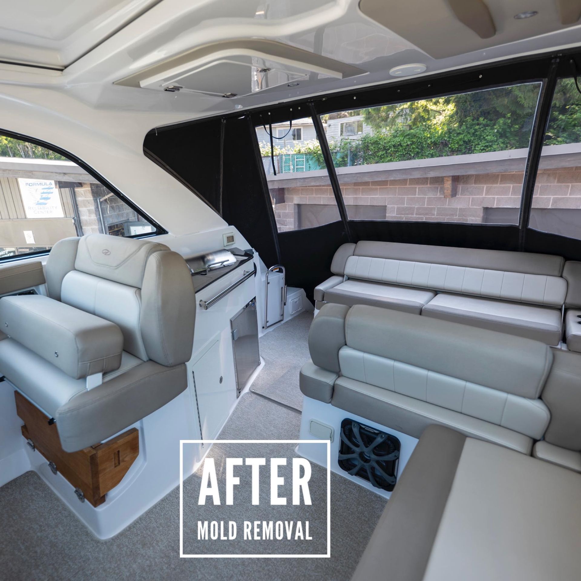 Interior of a boat cabin after mold removal, showing seats, windows, and surfaces.