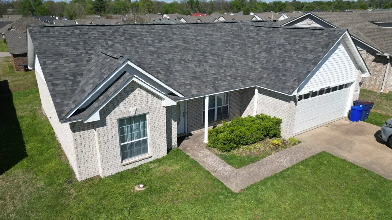 Architectural shingle installation on a green residential home in Maryland.