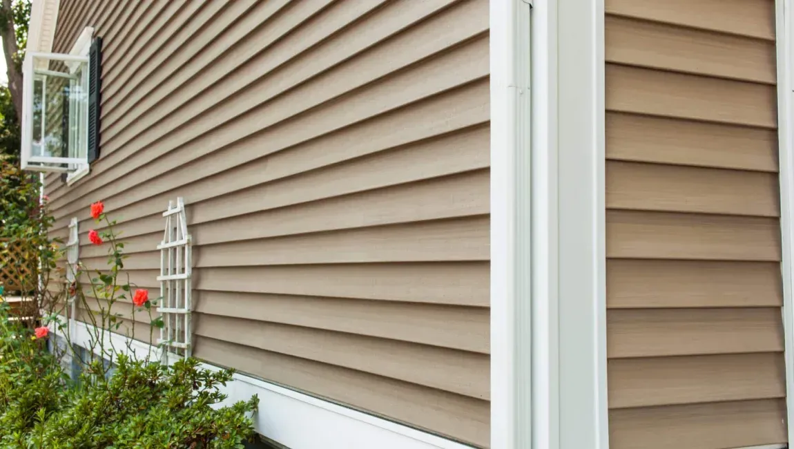 New tan vinyl siding installation on a Maryland home.