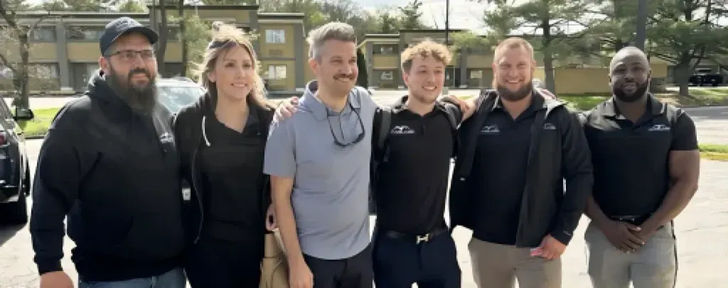 Vanguard Roofing & Construction team in front of residential home