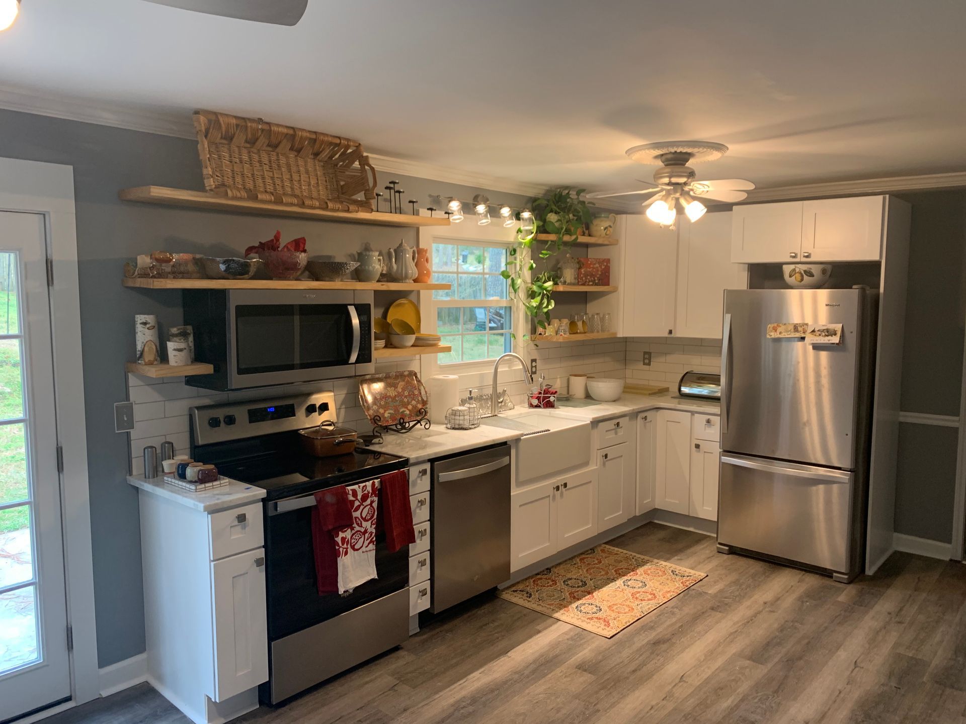 A kitchen with stainless steel appliances and white cabinets