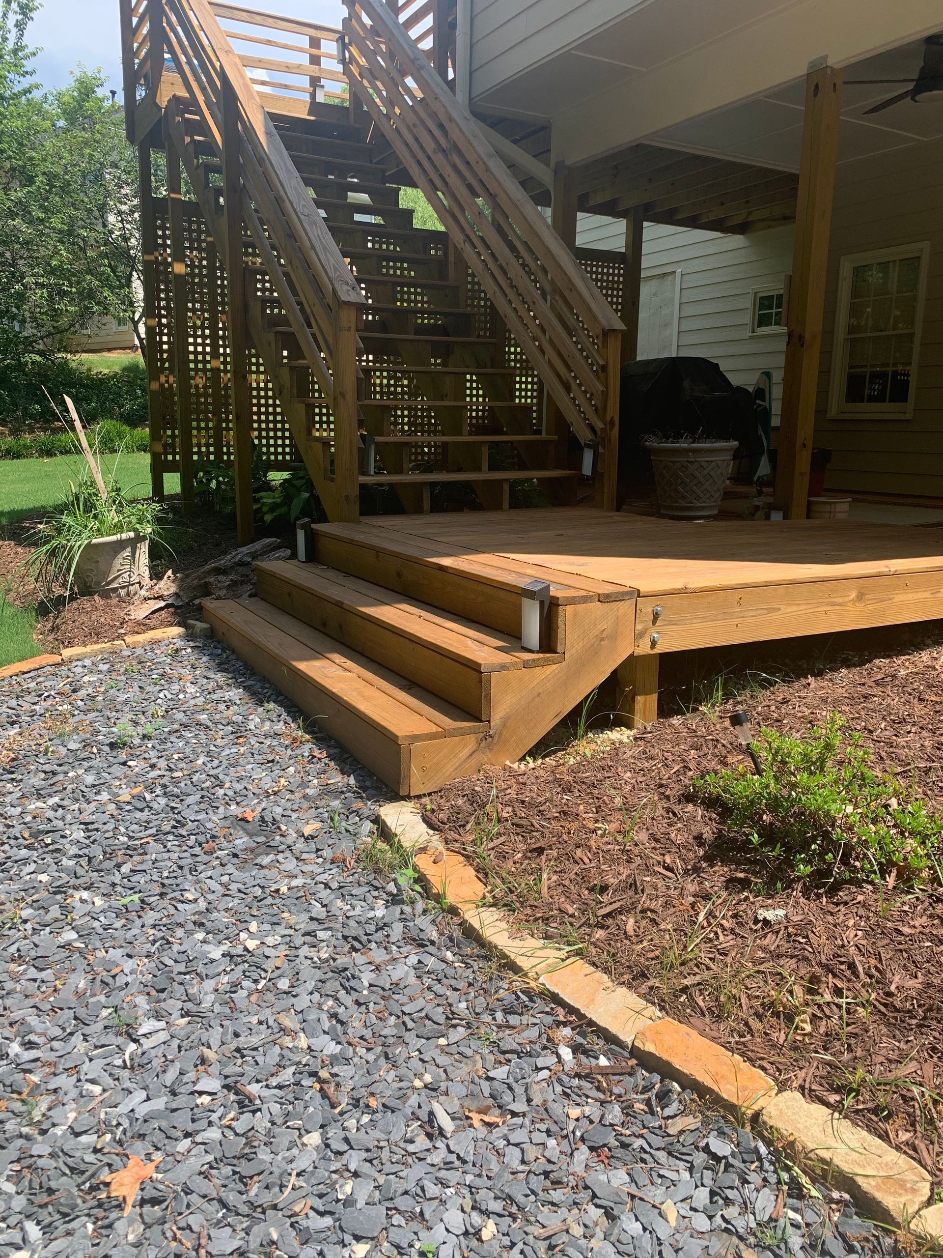 A wooden deck with stairs leading up to it.