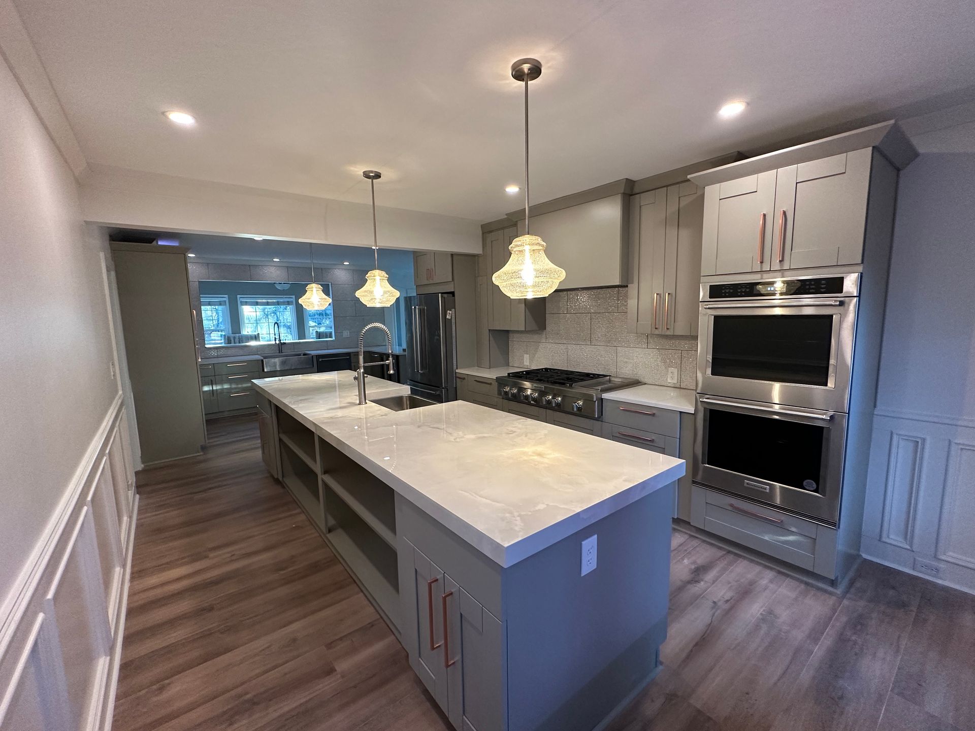 A kitchen with a large island and stainless steel appliances.