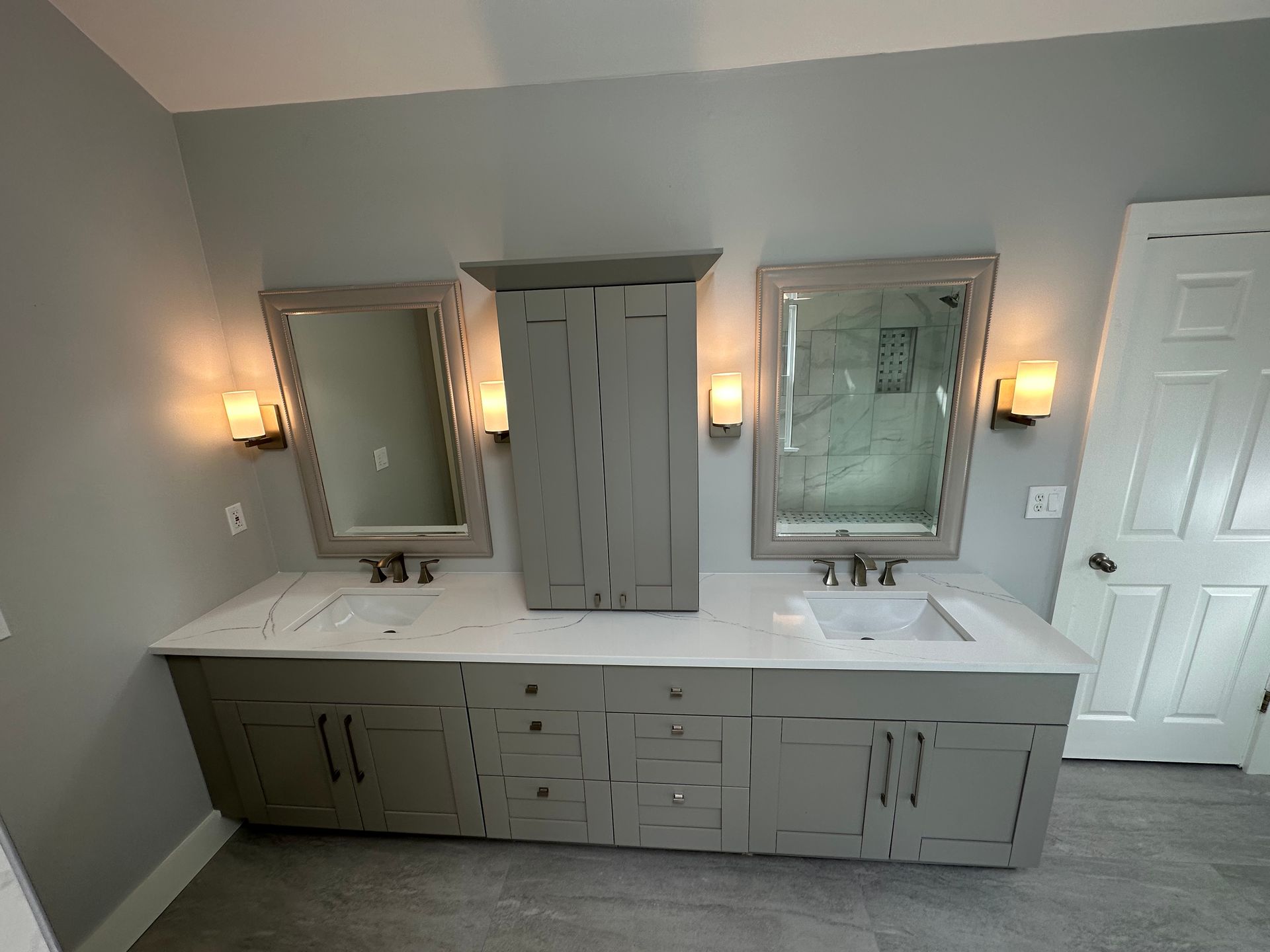 A bathroom with two sinks and two mirrors.