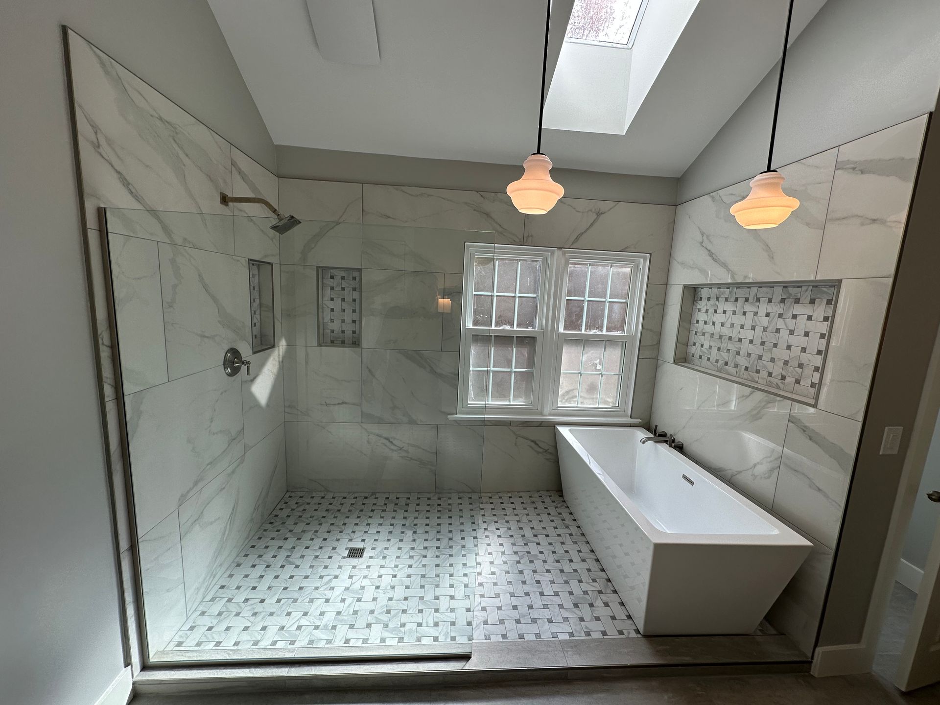 A bathroom with a walk in shower and a bathtub