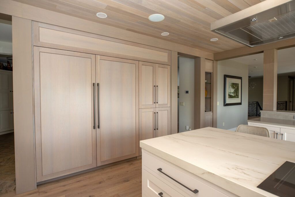 There is a large island in the middle of the kitchen.