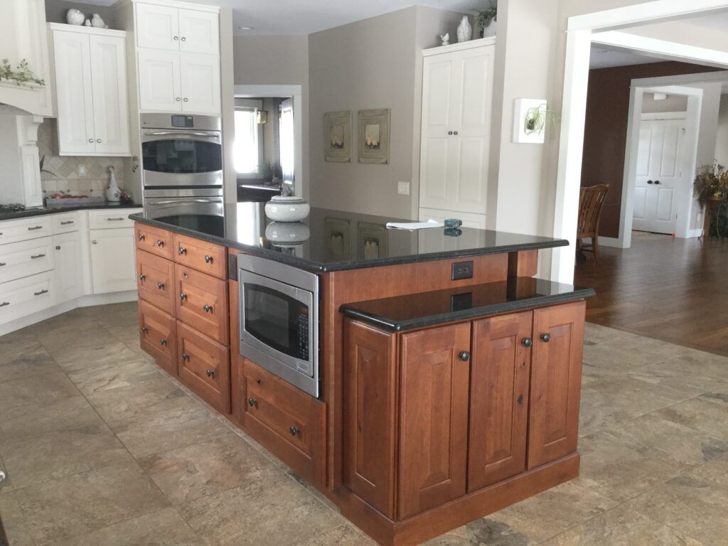 A large kitchen with a large island in the middle and a lot of windows.