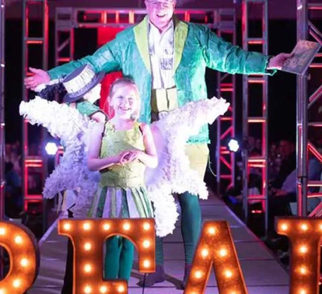 A man and a little girl are standing in front of a sign that says star