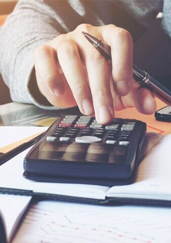 Man Using Calculator for Tax Preparation — S & S Tax And Financial Services, Inc. in Linden, NJ