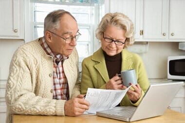 Couple with Laptop Checking their Retirement Plan — S & S Tax And Financial Services, Inc. in Linden, NJ