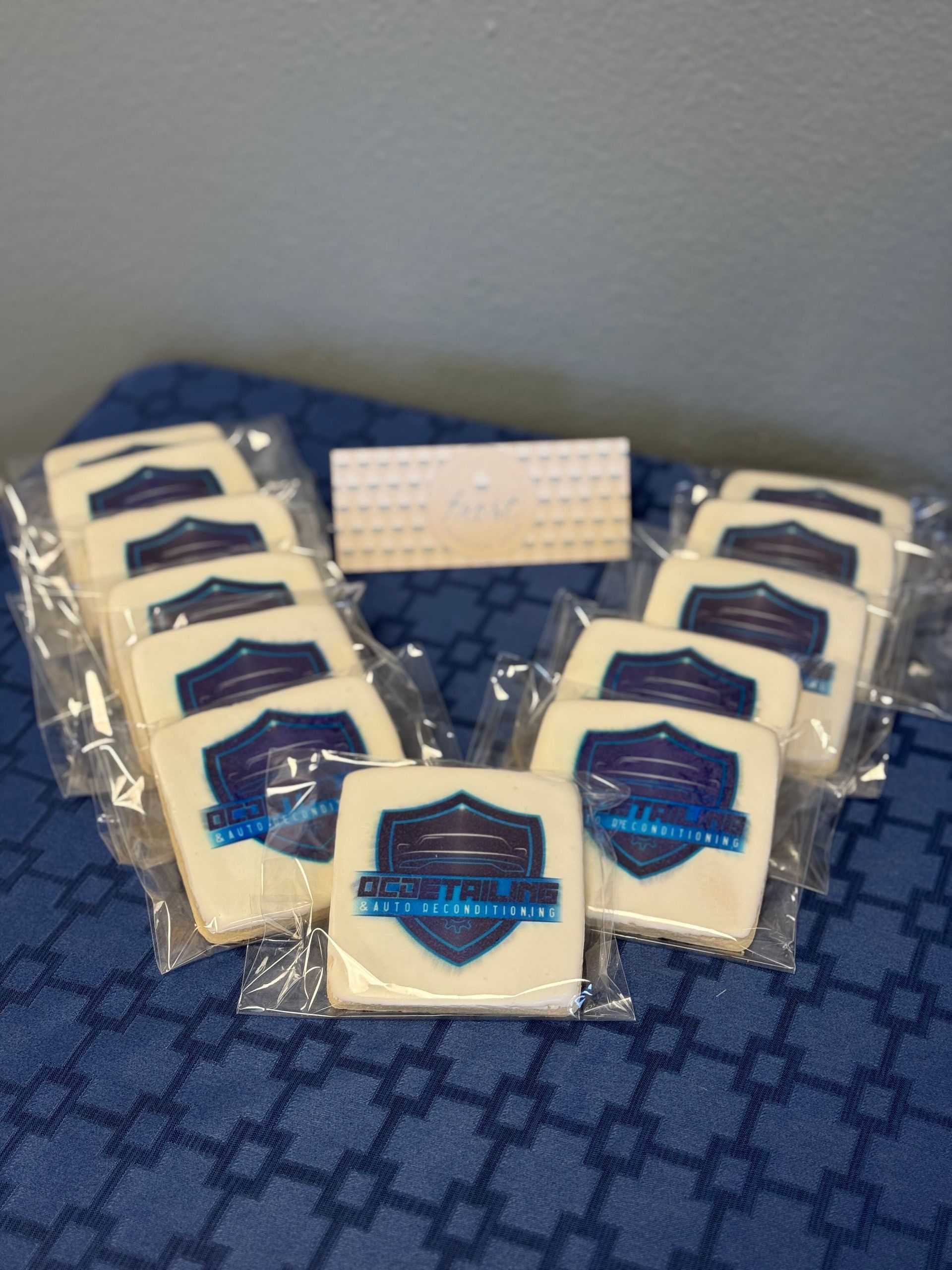 A bunch of cookies with logos on them are sitting on a table.