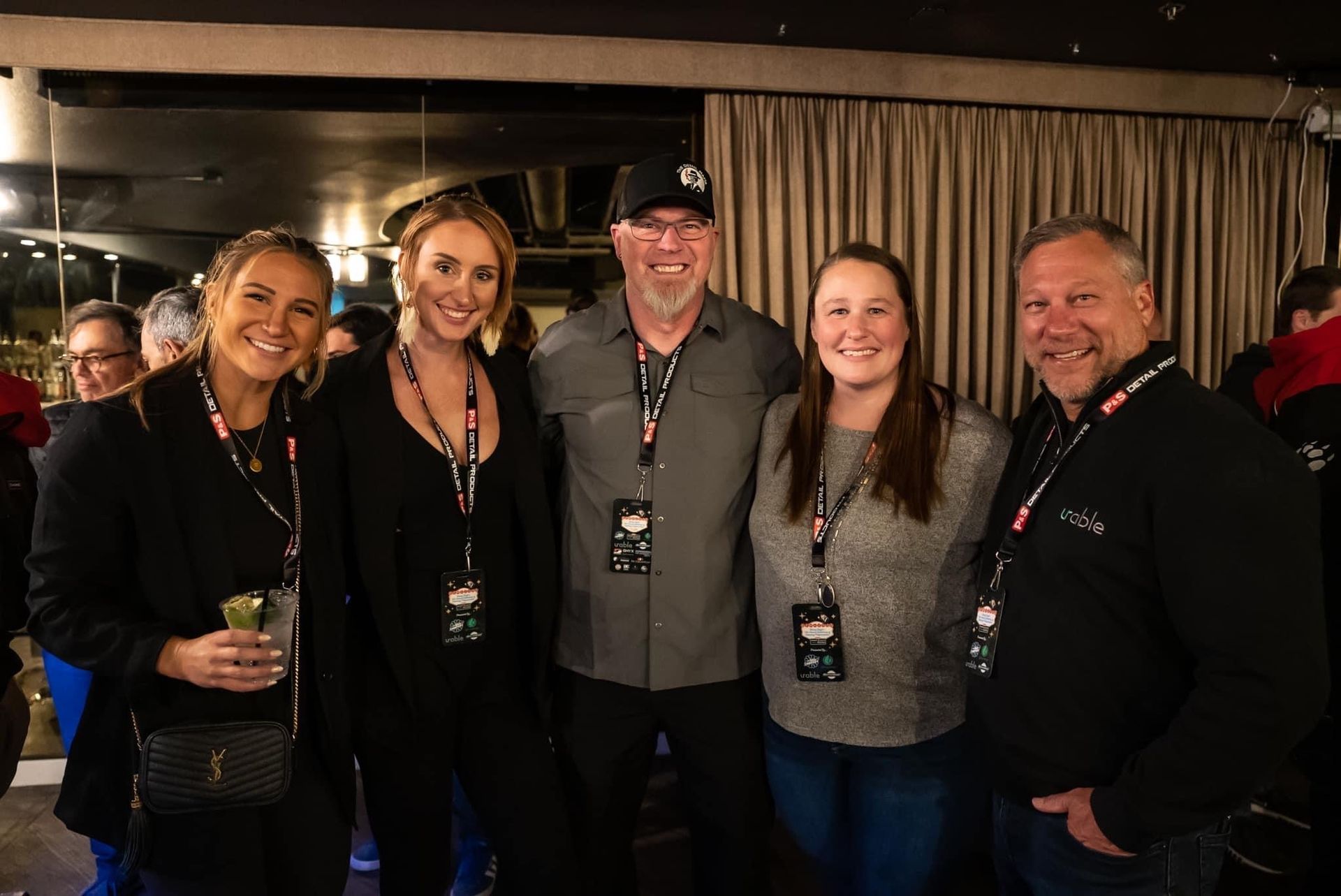 A group of people are posing for a picture together in a room.