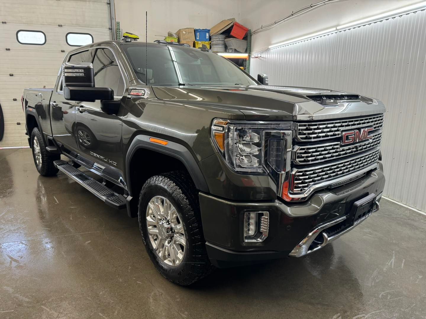 A gmc sierra 2500 pickup truck is parked in a garage.
