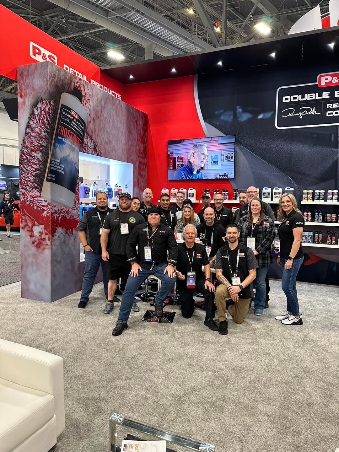 A group of people are posing for a picture at a convention.