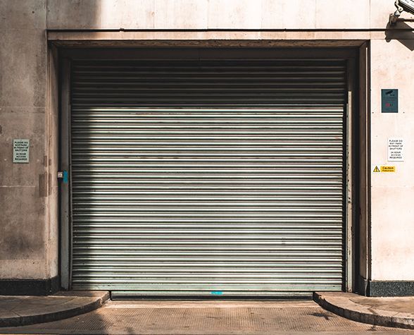 a garage door is closed on the side of a building .
