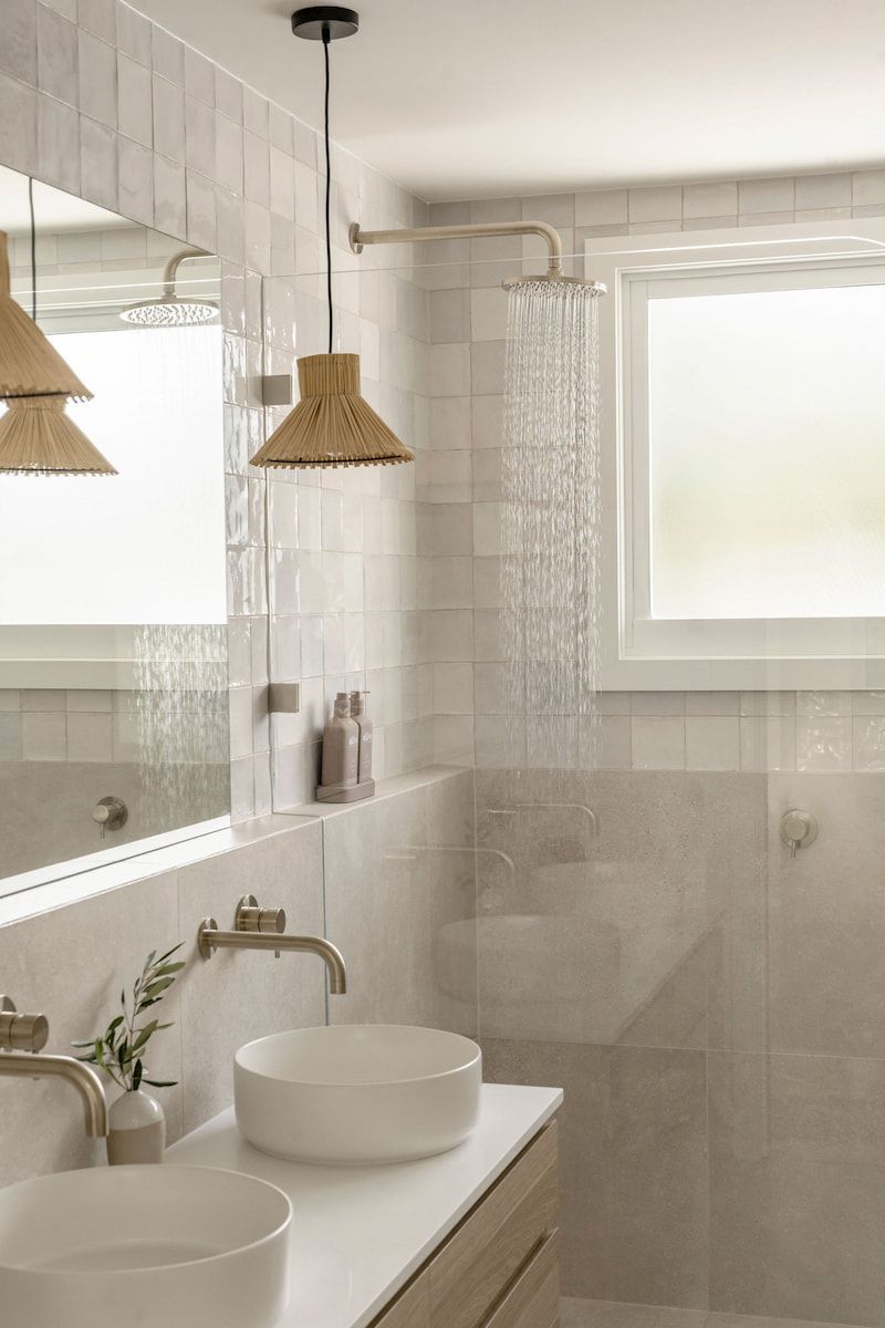 Bathroom With White Tile Walls, Two Sinks, and a Showerhead — Goode By Design in Unanderra, NSW