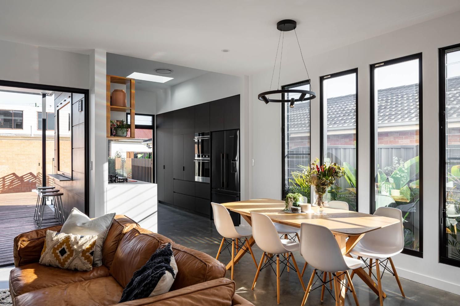 A Living Room and Dining Room in A House with A Table and Chairs — Goode By Design in Sydney Joinery, NSW