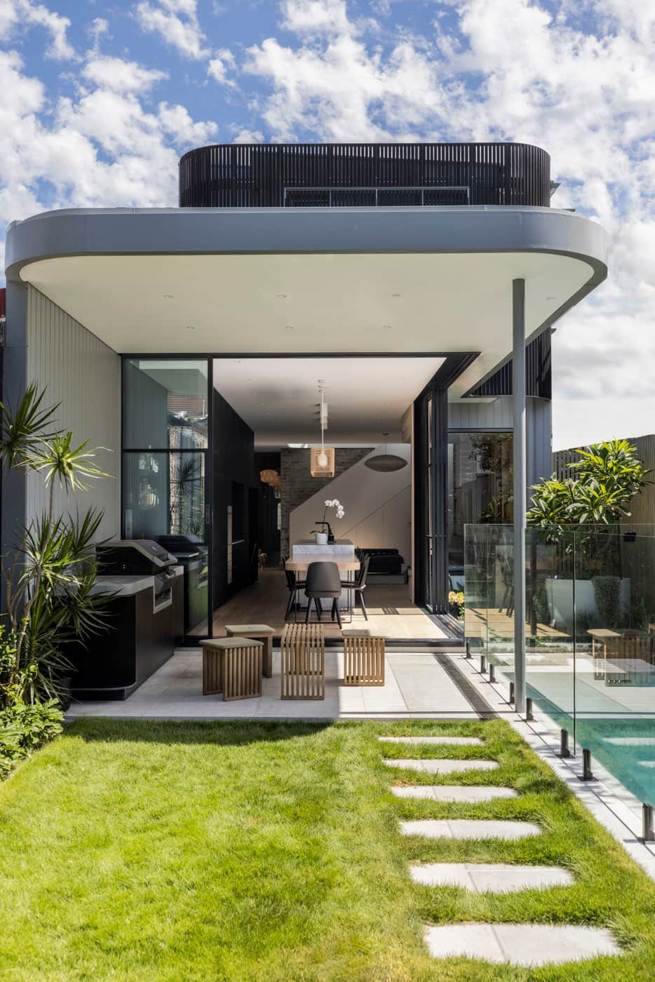 A Modern House With a Large Lawn in Front of It — Goode By Design in Unanderra, NSW