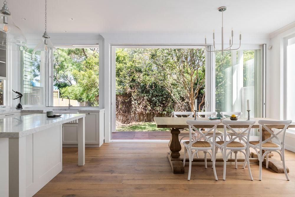 A Kitchen and Dining Room in A House with A Table and Chairs — Goode By Design in Unanderra, NSW