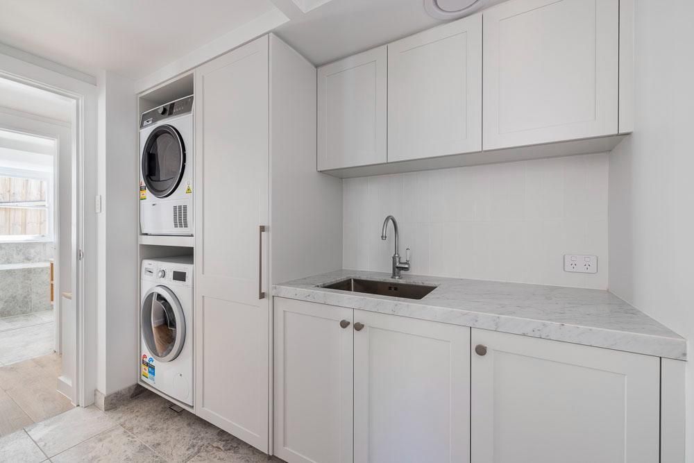 A Laundry Room with A Washer and Dryer and A Sink — Goode By Design in Unanderra, NSW