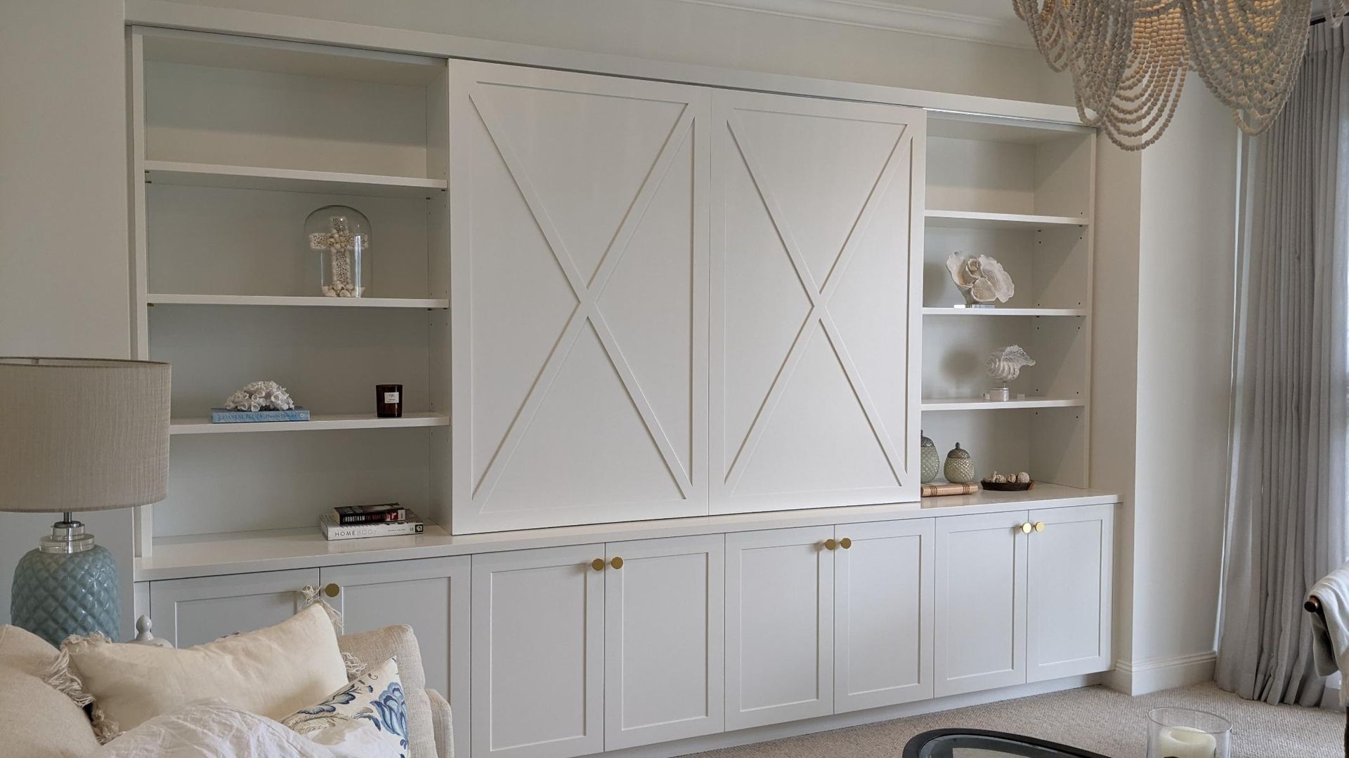 A Living Room with White Cabinets, Shelves, a Couch and A Lamp  — Goode By Design in Unanderra, NSW