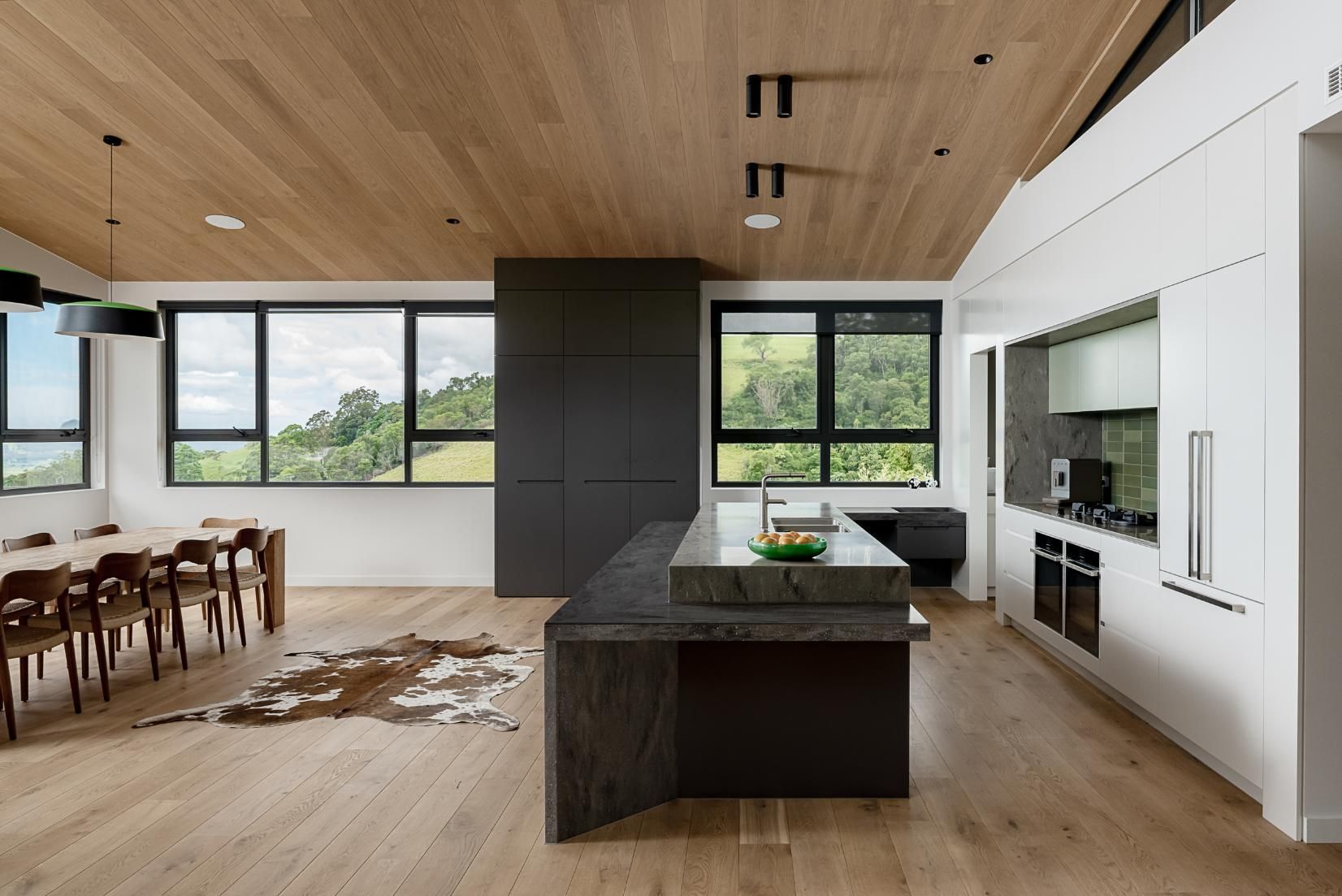 A Kitchen with A Large Island in The Middle and A Dining Room in The Background — Goode By Design in Unanderra, NSW