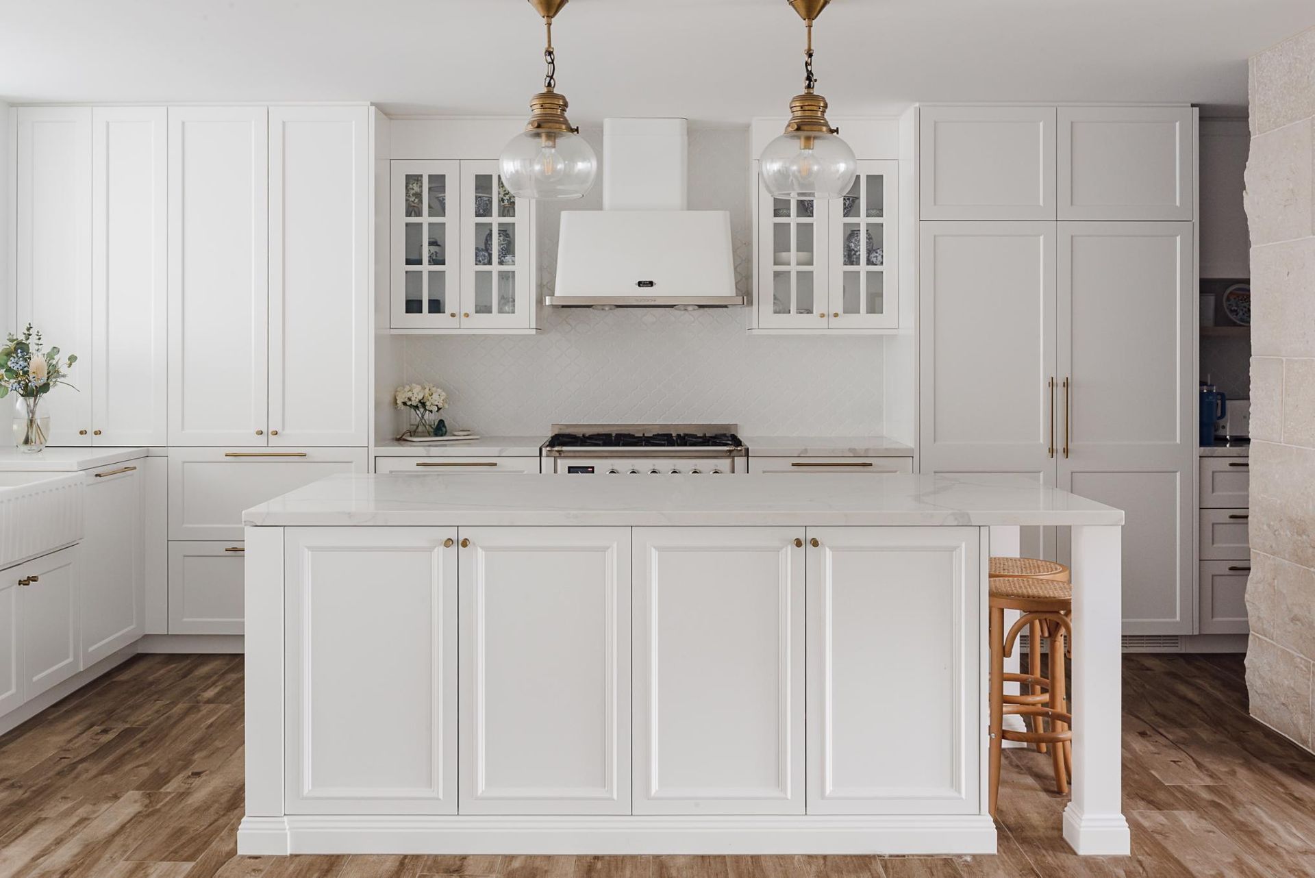 A Kitchen with White Cabinets, a Stove, a Refrigerator, and A Large Island — Goode By Design in Unanderra, NSW