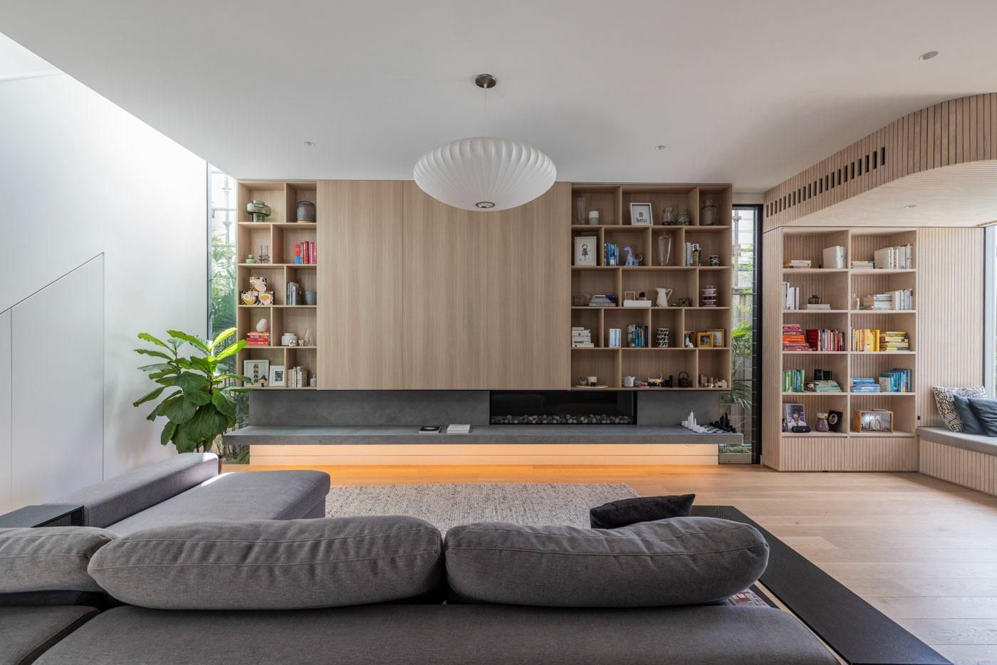 A Living Room with A Couch, Shelves, and A Fireplace — Goode By Design in Unanderra, NSW