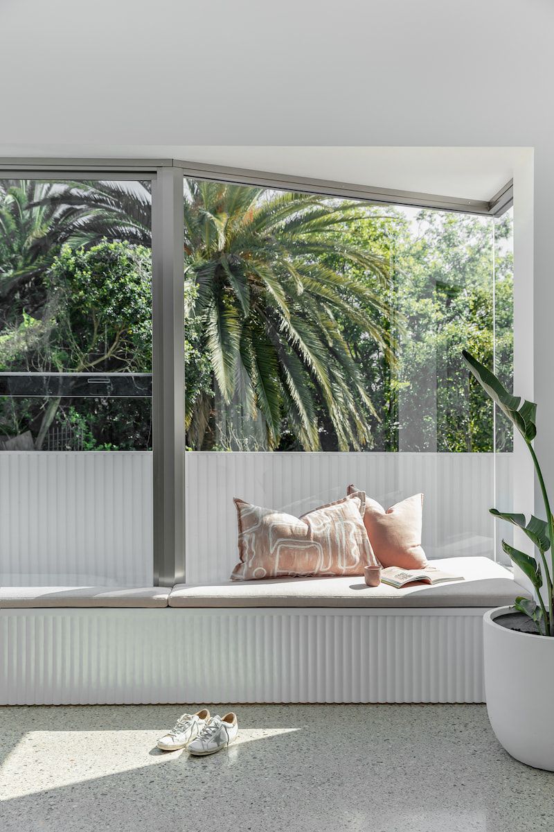 A Window Seat With Cushions Overlooks Lush Greenery — Goode By Design in Unanderra, NSW