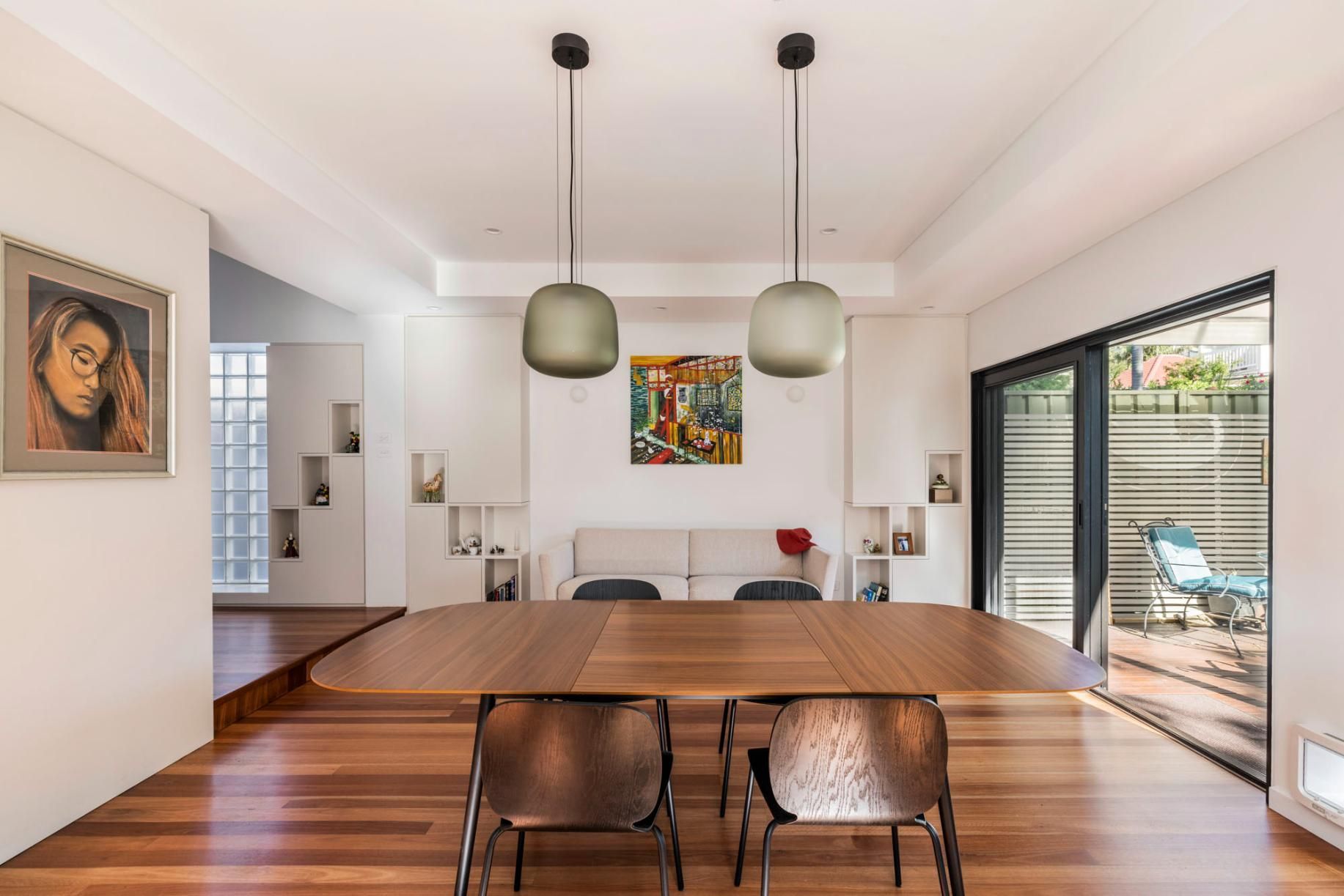 A Dining Room with A Wooden Table and Chairs and A Painting on The Wall — Goode By Design in Unanderra, NSW