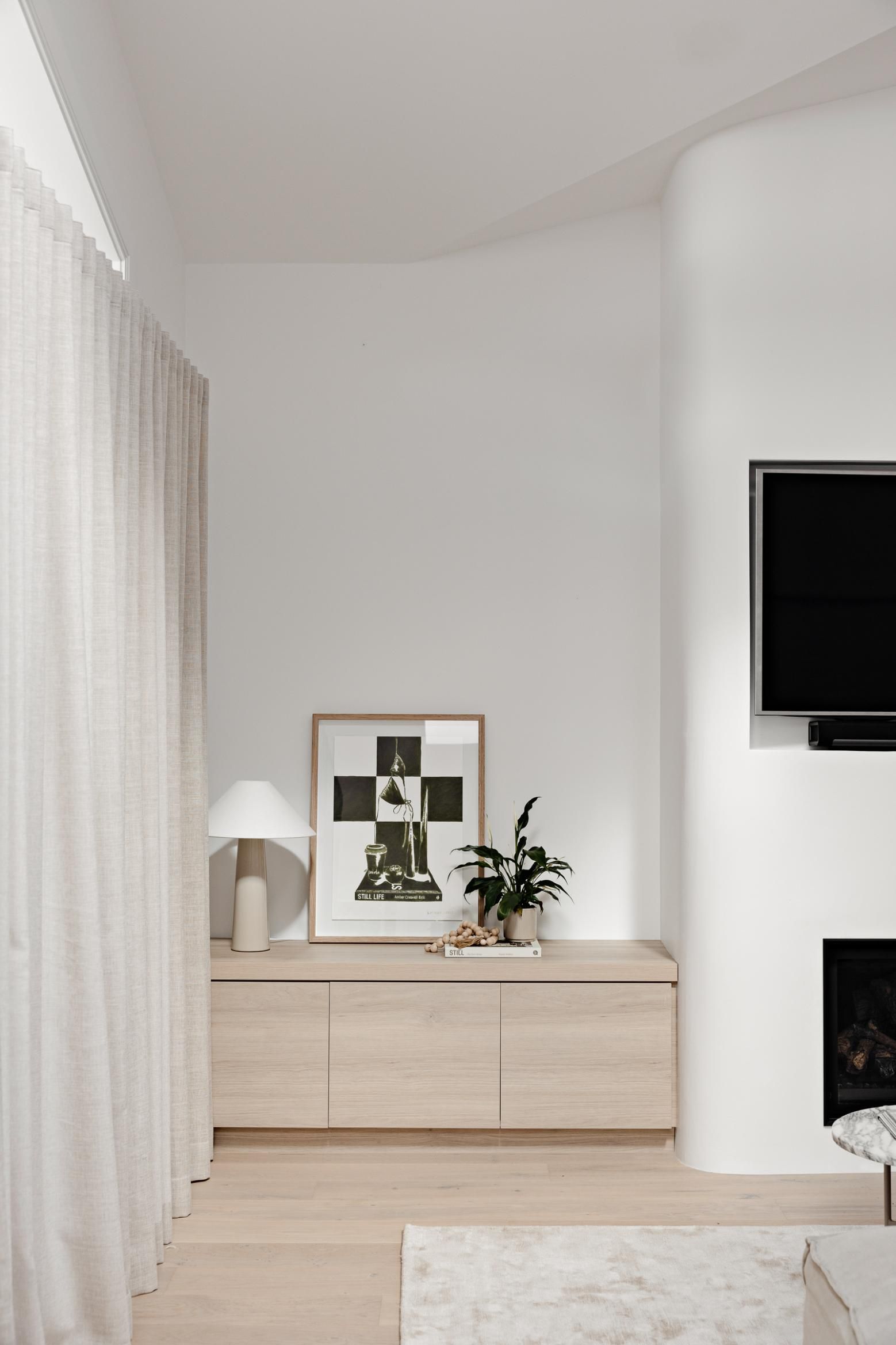 A Living Room with A Fireplace and A Flat Screen TV — Goode By Design in Unanderra, NSW