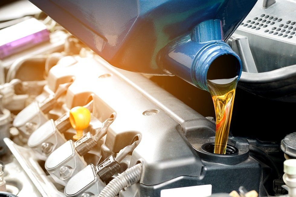 Pouring Oil In Car Engine — Heavy & Light Vehicle Repairs in Callemondah, QLD