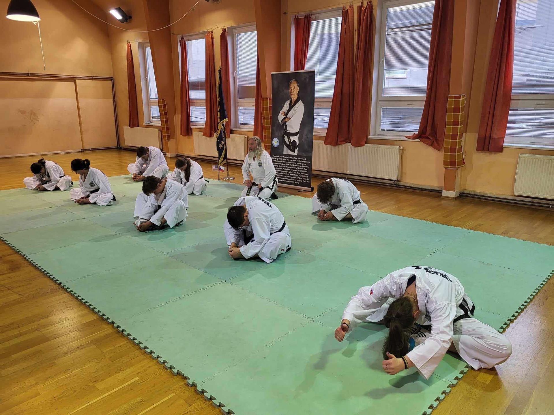 A group of people are practicing martial arts in a gym.