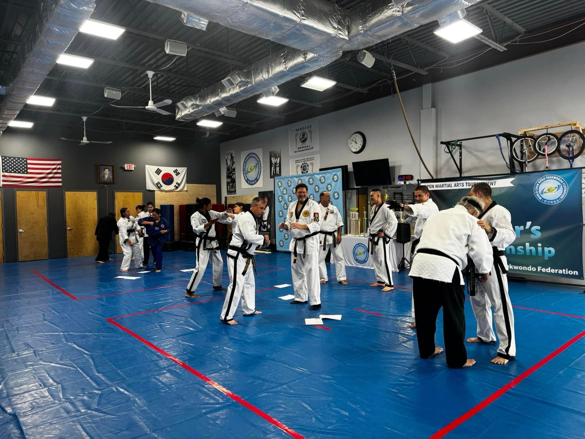 A group of people are practicing martial arts in a gym.