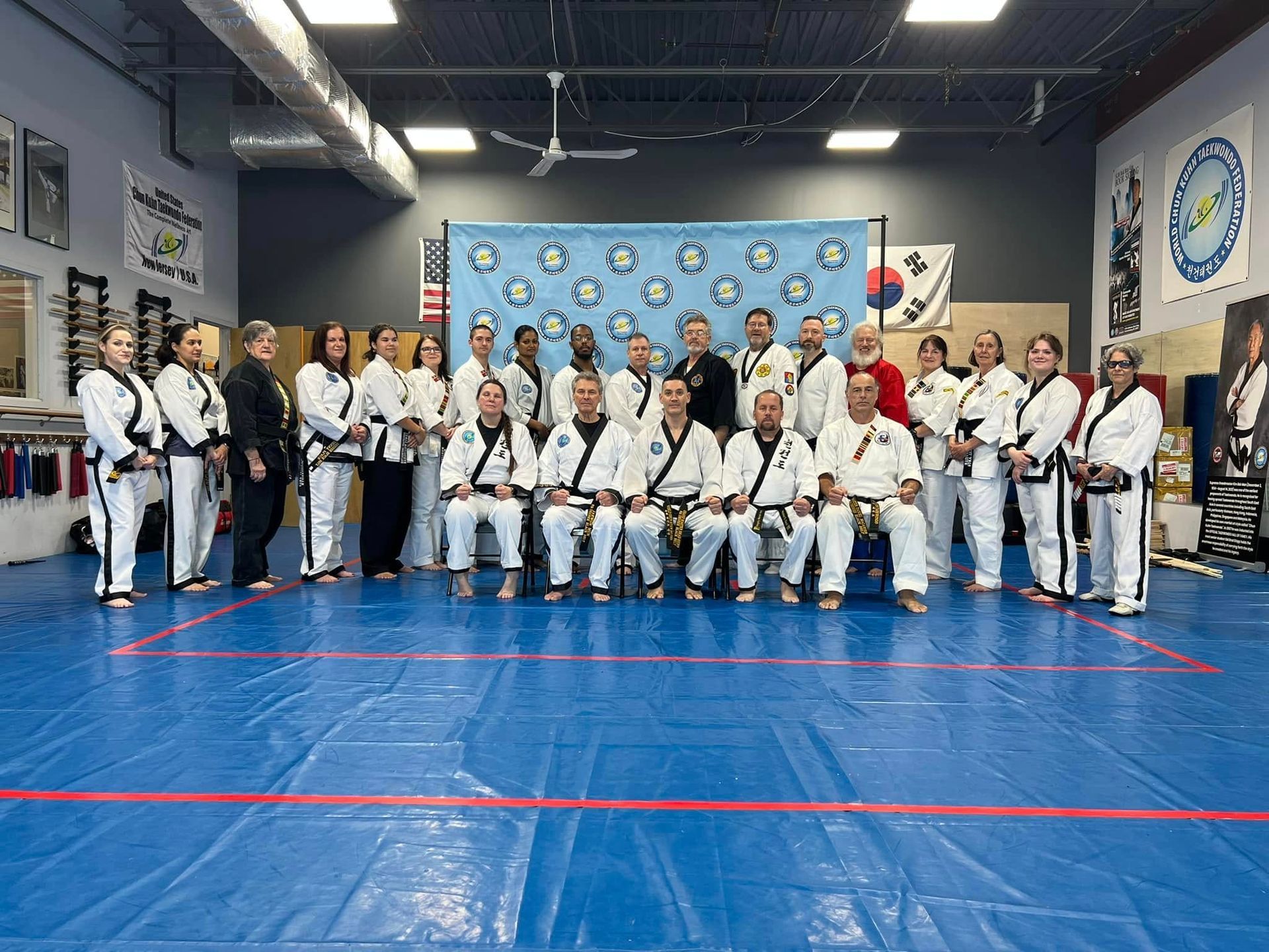 A group of people are posing for a picture in a gym.