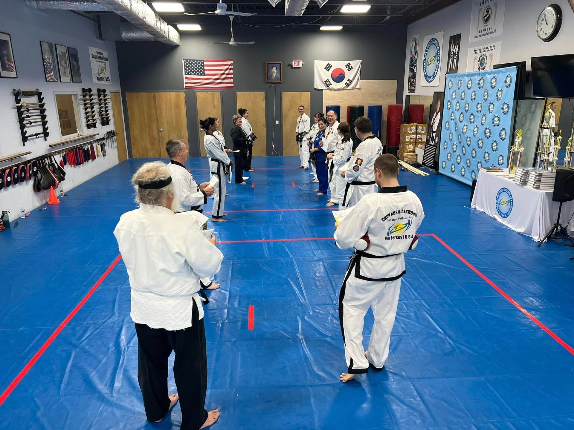 A group of people are practicing martial arts in a gym.