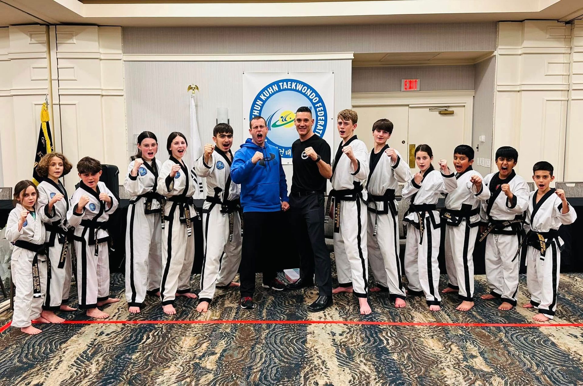 A group of people in karate uniforms are posing for a picture.