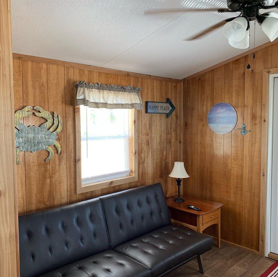 A living room with a couch and a ceiling fan