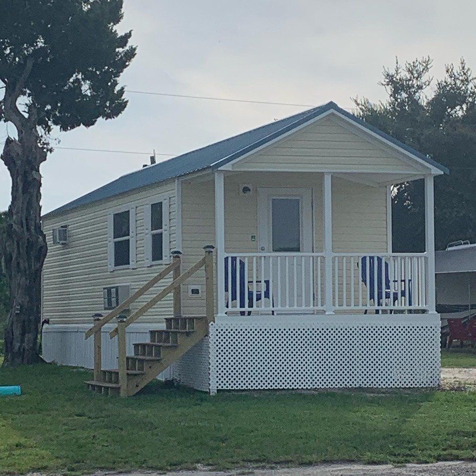 A small house with a porch and stairs