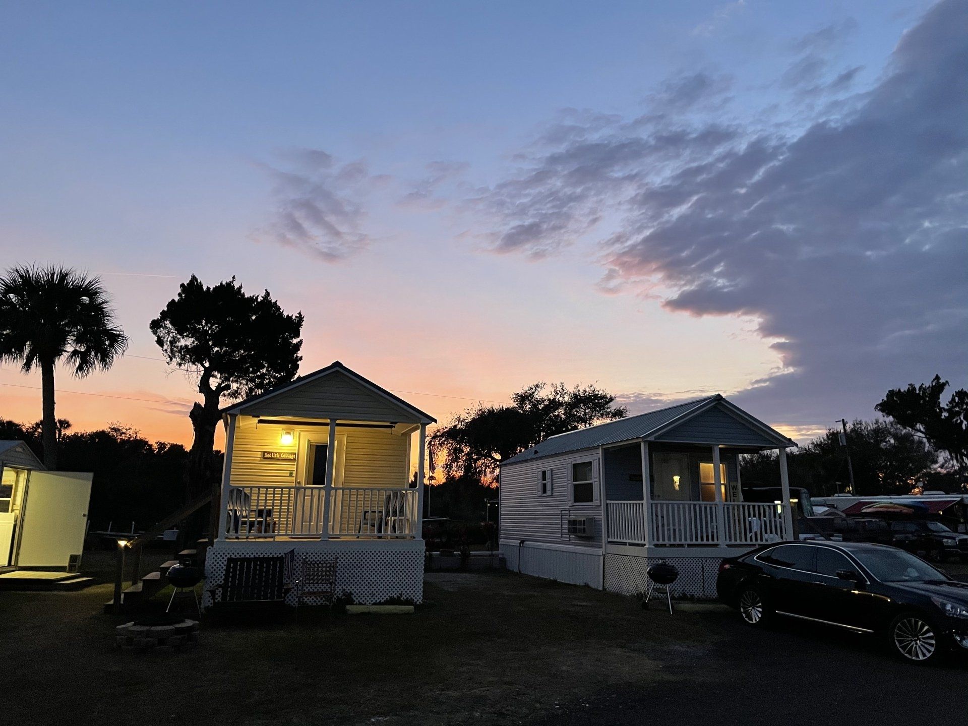 A couple of houses with a car parked in front of them