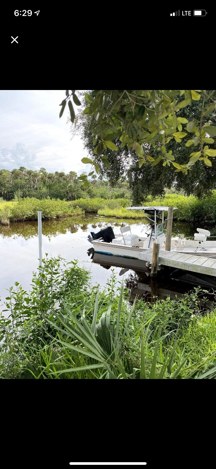 A boat is docked at a dock on a river.