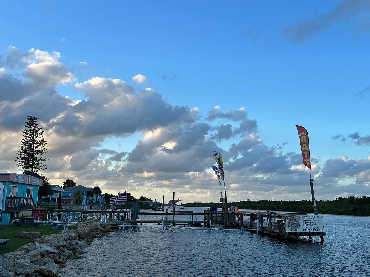 A dock overlooking a body of water with a blue sky in the background.