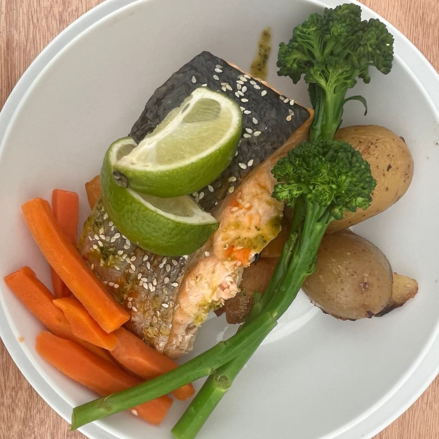 A plate of food with broccoli carrots and potatoes