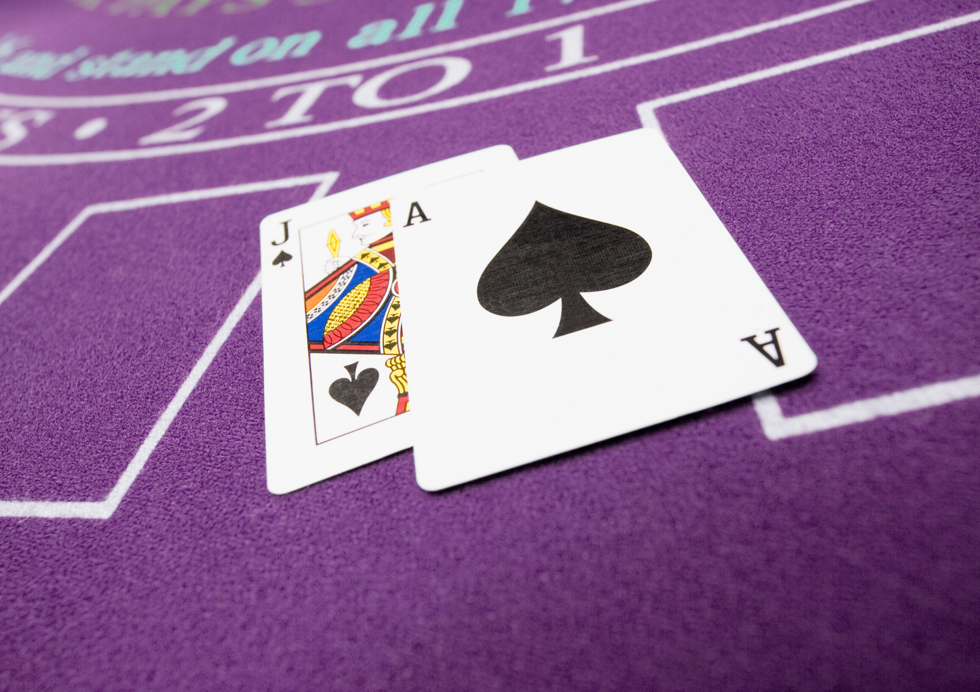 What Makes Blackjack So Popular? Two cards hitting a blackjack on a table.