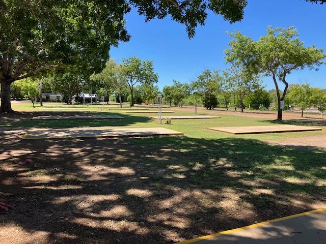 Grassy Park With Trees Under a Blue Sky, Camping Areas Visible — Karumba Point Holiday Tourist Park in Karumba, QLD