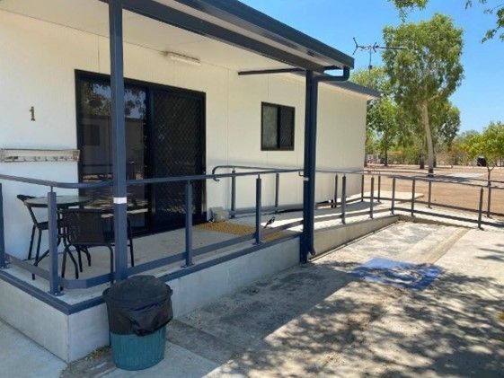 White Cabin With a Ramp, Porch, and a Black Table and Chairs — Karumba Point Holiday Tourist Park in Karumba, QLD