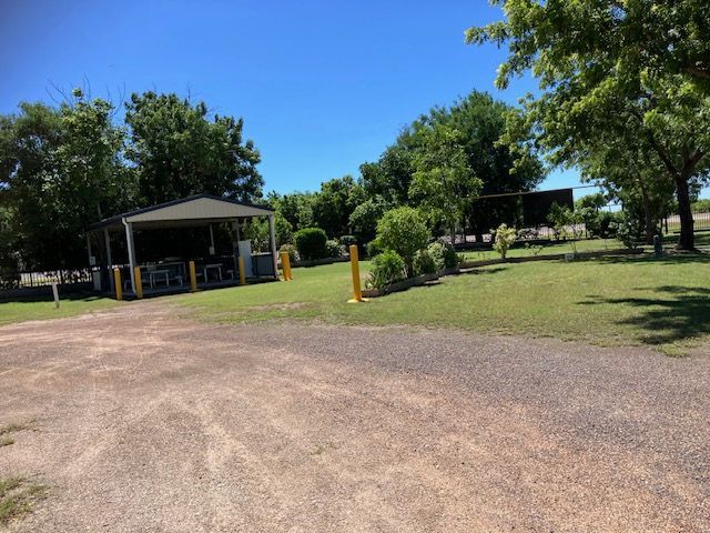 Gravel Parking Area Next to a Grassy Area With Trees — Karumba Point Holiday Tourist Park in Karumba, QLD