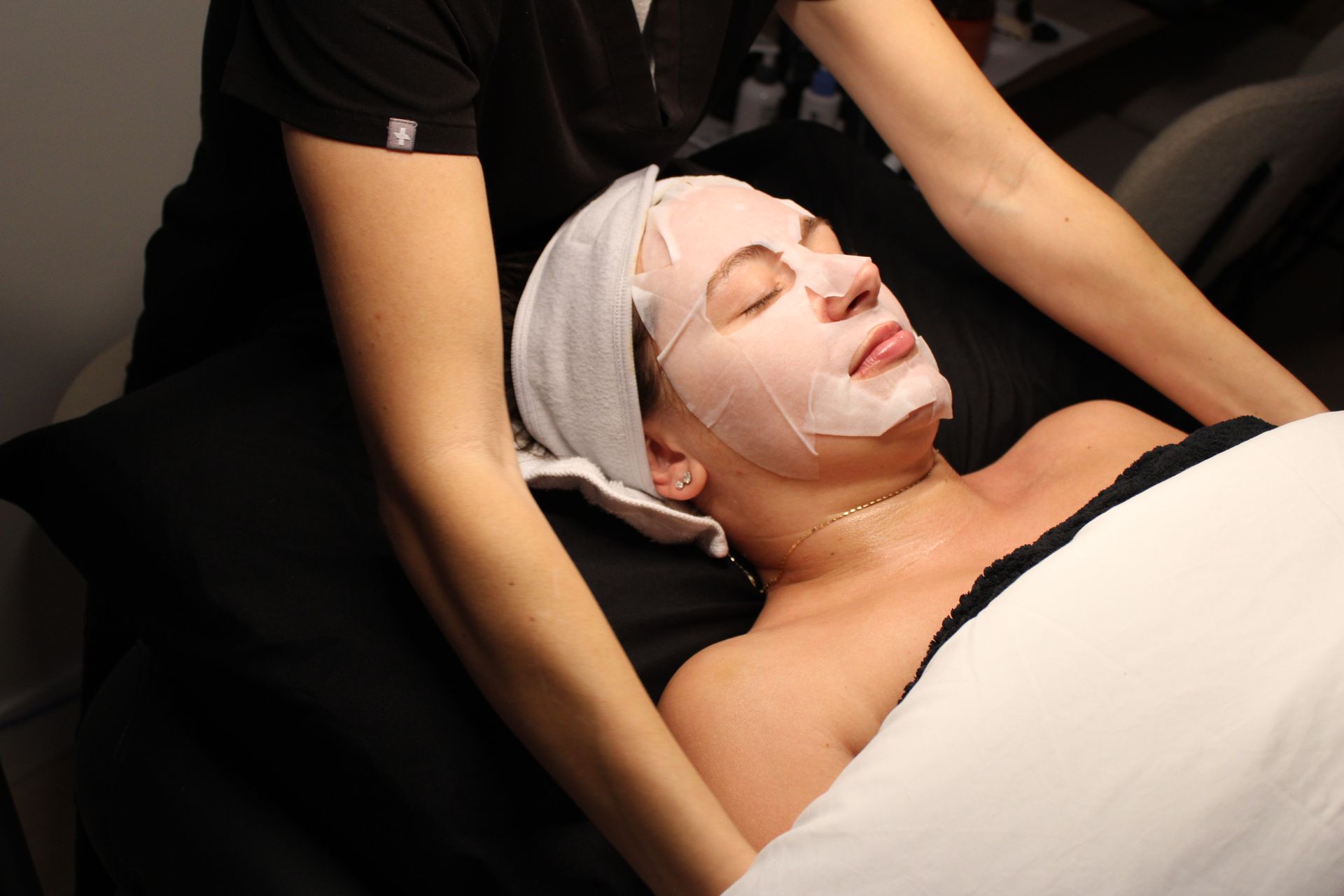 A woman is getting her legs waxed in a beauty salon.