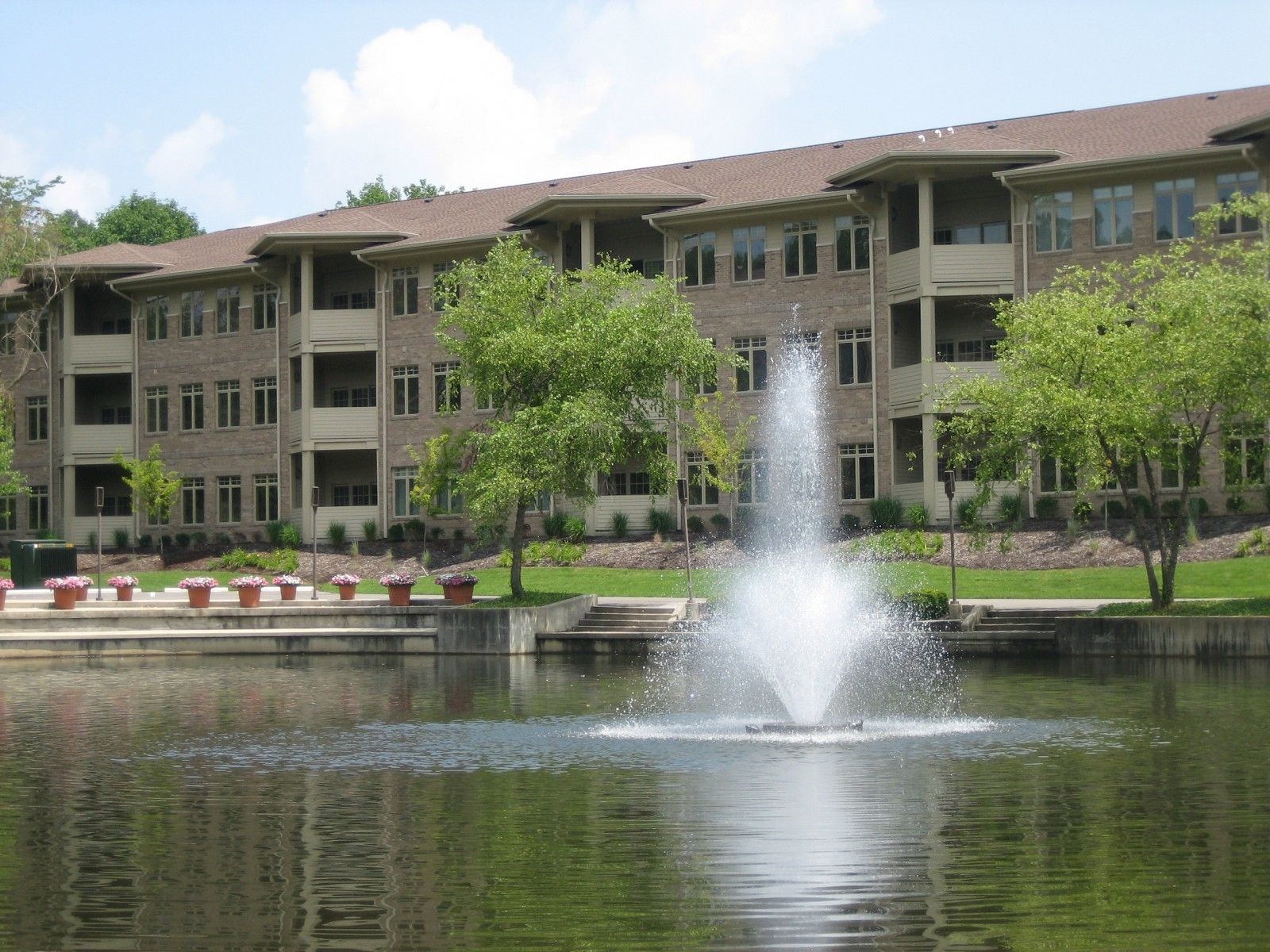 A large building with a fountain in front of it